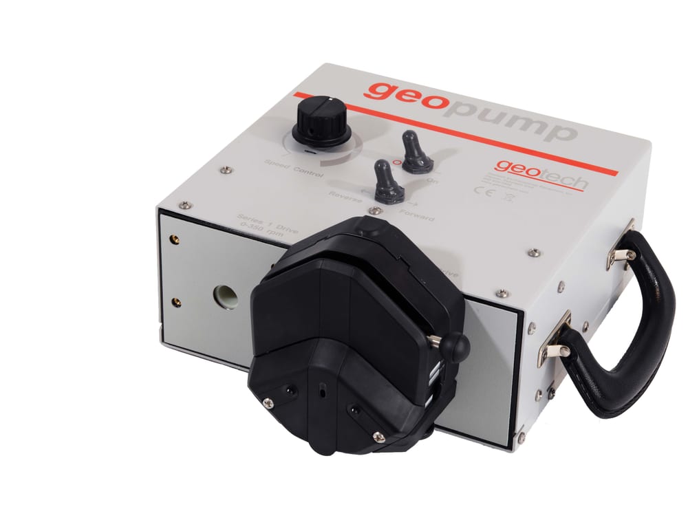 Close-up of the Geopump controller and pump head, showing the speed control dial and forward/reverse switches