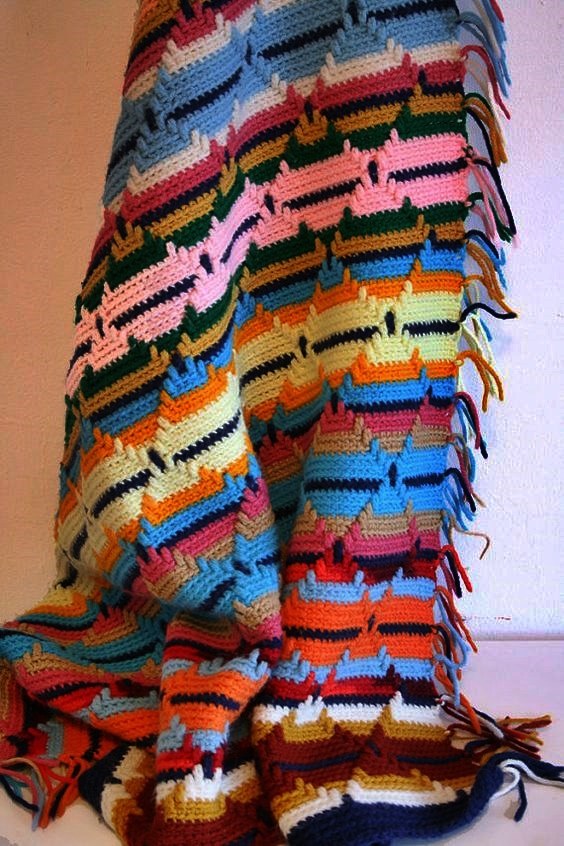 A brightly striped, multicolor crocheted blanket with tasseled fringe — the early Native American textile artifact that XRF analysis revealed had been preserved with arsenic